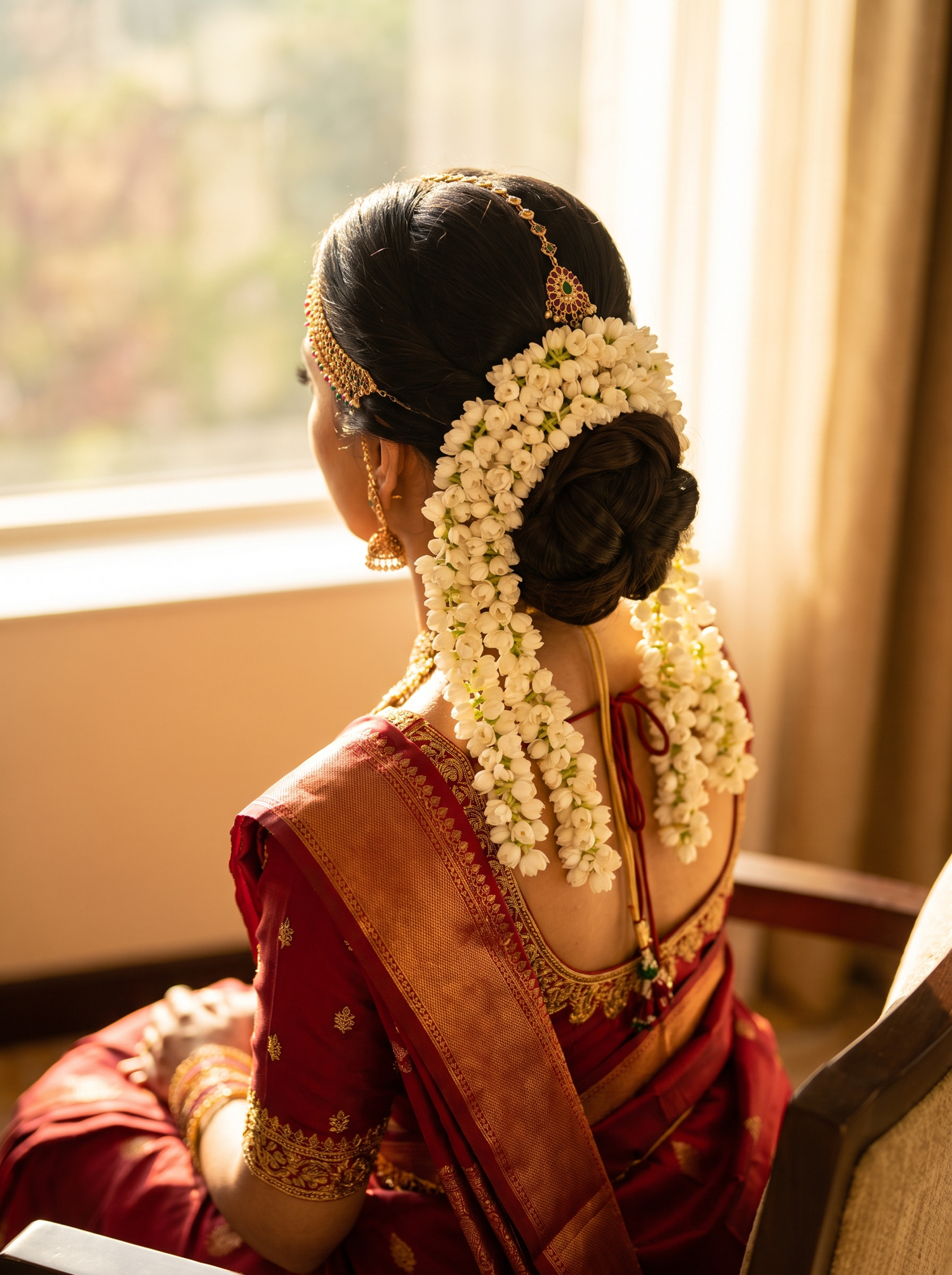 A bride's low bun dressed with jasmine flowers
